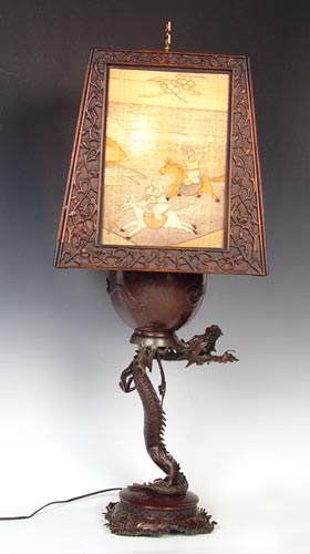 Appraisal: JAPANESE DRAGON LAMP WITH CARVED WOODEN SHADE Figural bronzed metal