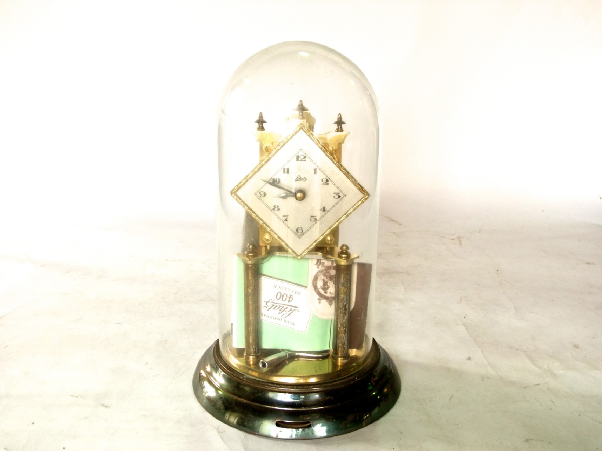 Appraisal: A Schatz day anniversary clock with dome key spare suspension