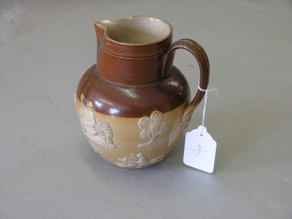 Appraisal: A Doulton Lambeth stoneware harvest jug applied with typical bas-reliefs