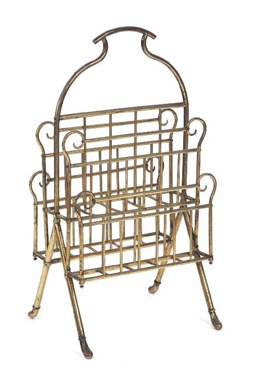 Appraisal: A late Victorian gilt brass magazine rack the arched handle