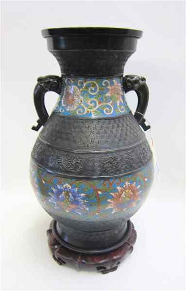 Appraisal: CHINESE CHAMPLEVE ENAMEL BRONZED METAL URN having open figural side