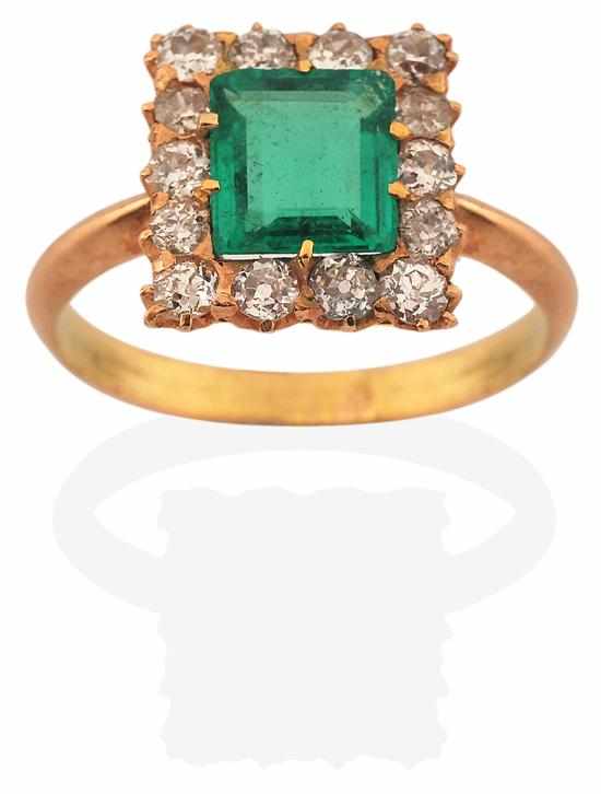 Appraisal: AN EMERALD AND DIAMOND CLUSTER RING Centrally set with an