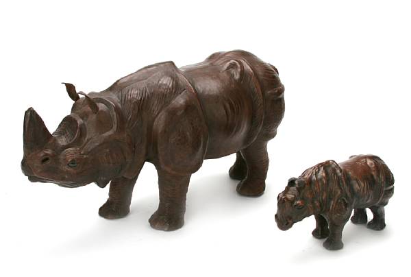 Appraisal: A group of three leather covered figures of rhinoceroses height