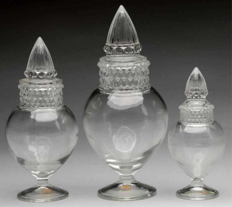 Appraisal: Lot of Heck Spired Urn Clear Apothecary Jars Description Set