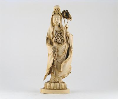 Appraisal: A Japanese ivory carving of Kwannon standing holding a lotus