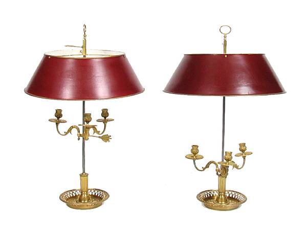 Appraisal: A pair of Empire style bouillotte lamps with tole shades