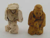 Appraisal: Two Japanese ivory netsuke one stained carrying a carp one