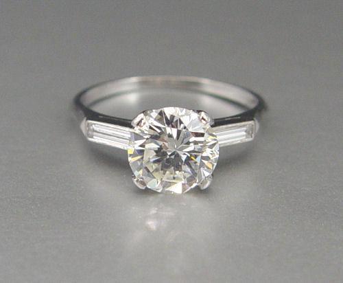 Appraisal: PLATINUM CT DIAMOND SOLITAIRE WITH BAGUETTES RING A single round