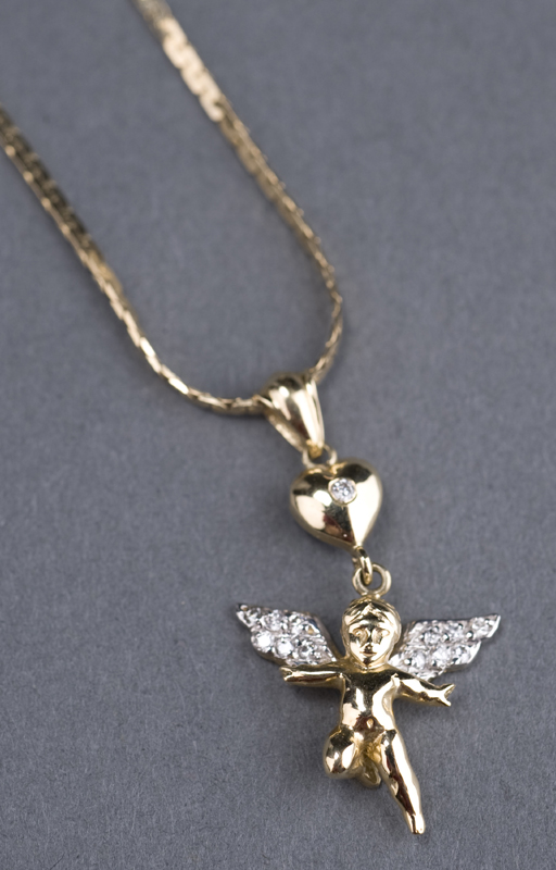 Appraisal: KT gold cupid charm with diamond wings The cupid measures