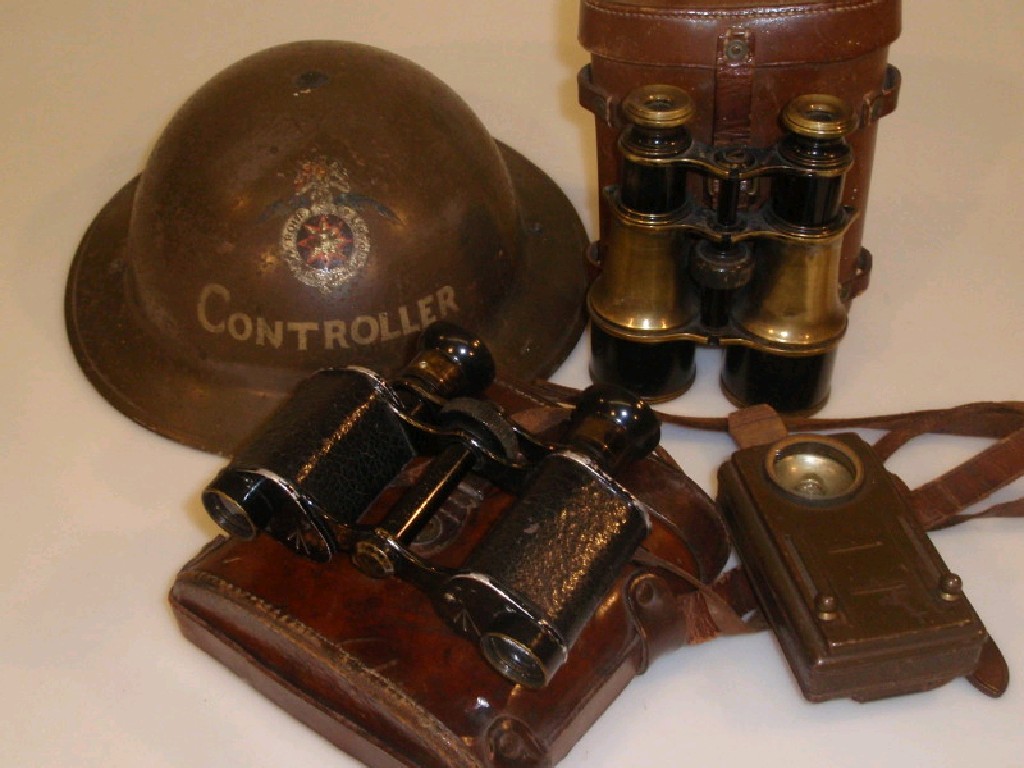 Appraisal: A WWII tin hat inscribed Controller with leather lining binoculars