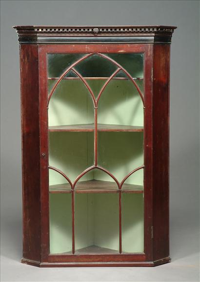 Appraisal: A George III mahogany astragal glazed corner cupboard circa with