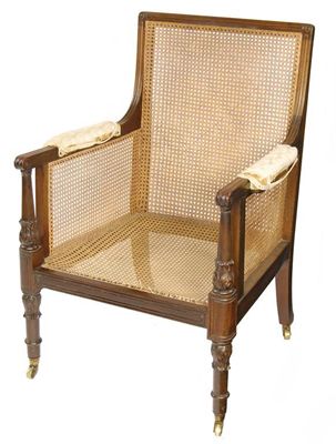 Appraisal: A George IV mahogany bergere with carved back sides and