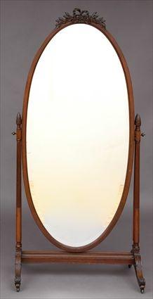 Appraisal: EDWARDIAN MAHOGANY CHEVAL MIRROR With oval beveled mirror carved with