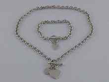 Appraisal: A white metal tests silver necklace with two heart pendants