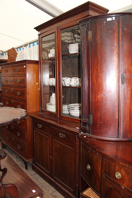 Appraisal: A MAHOGANY LIBRARY BOOKCASE CABINET with twin glazed door above