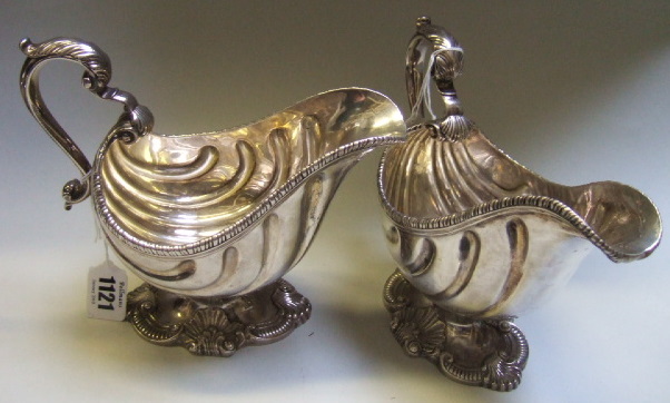 Appraisal: A pair of sauceboats each decorated with fluted sides and