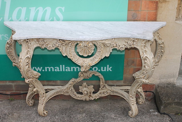 Appraisal: AN ITALIANATE PAINTED CONSOLE TABLE with serpentine marble top on