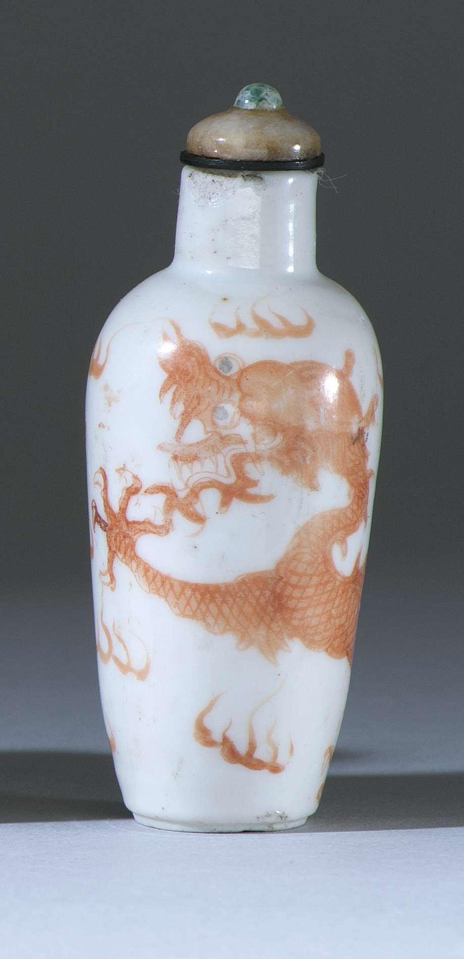 Appraisal: PORCELAIN SNUFF BOTTLE th CenturyIn temple jar form with rust-red