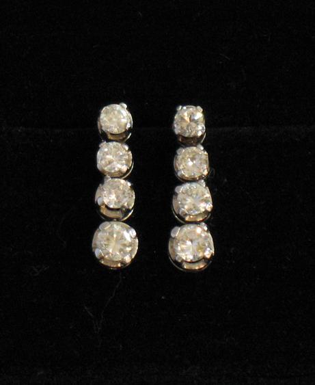 Appraisal: A PAIR OF DIAMOND DROP EARRINGS each reticulated train comprising