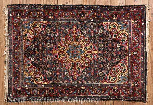 Appraisal: An Antique Persian Rug red and dark blue ground central