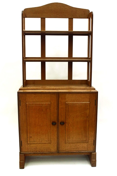 Appraisal: A golden oak and ebony strung cupboard with bookshelves over