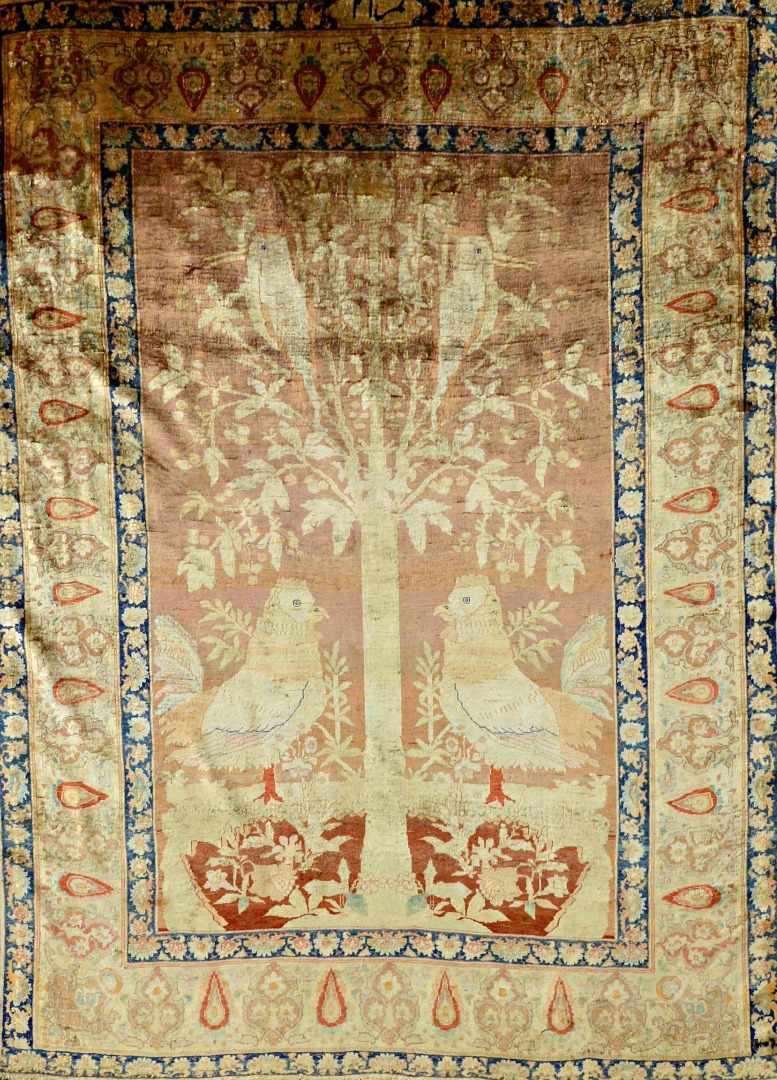 Appraisal: A silk Heriz tree of life rug the dark madder