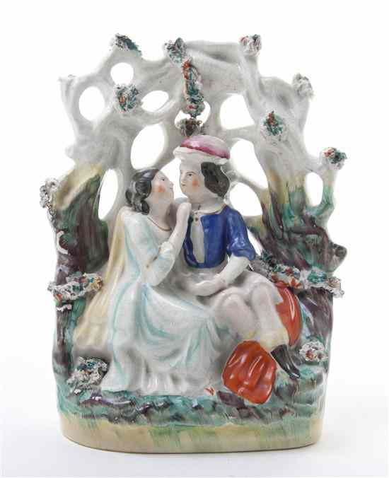 Appraisal: A Staffordshire Bocage Group depicting a courting couple seated beneath