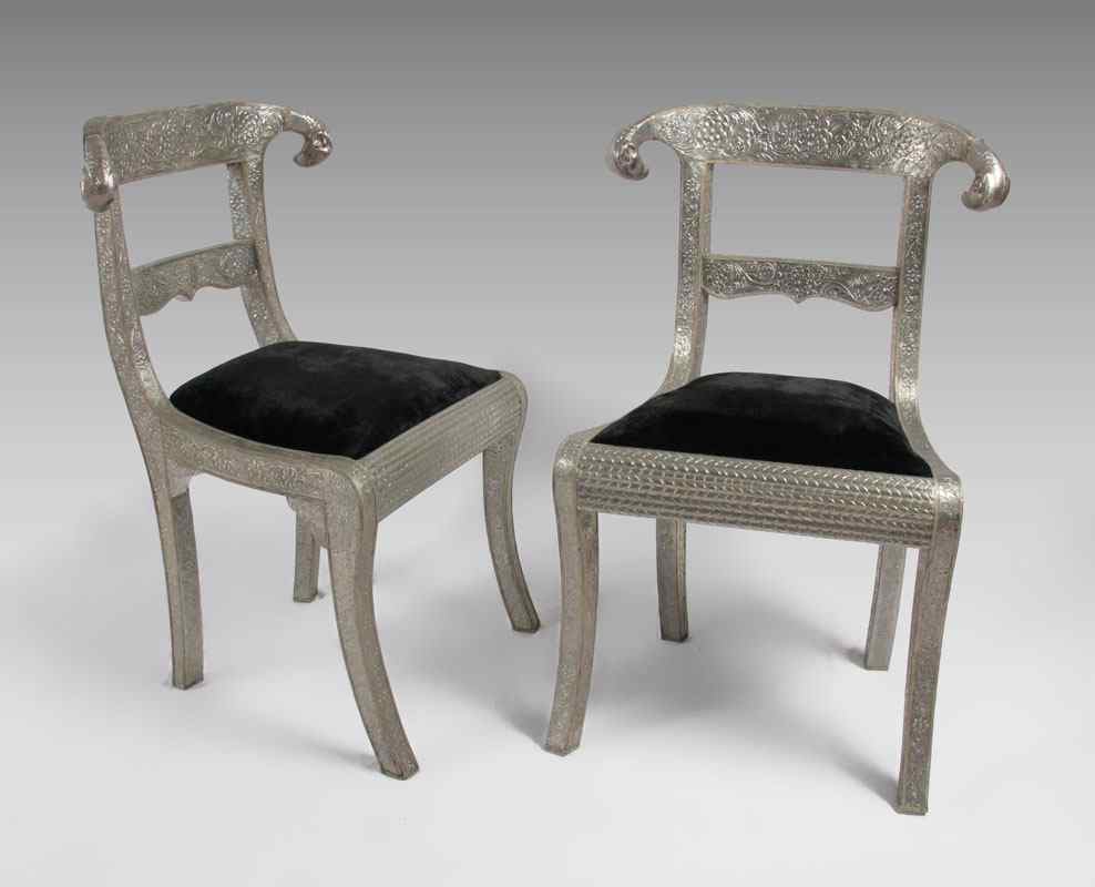 Appraisal: PR OF PERSIAN RAMS HEAD SIDE CHAIRS Embossed silver metal