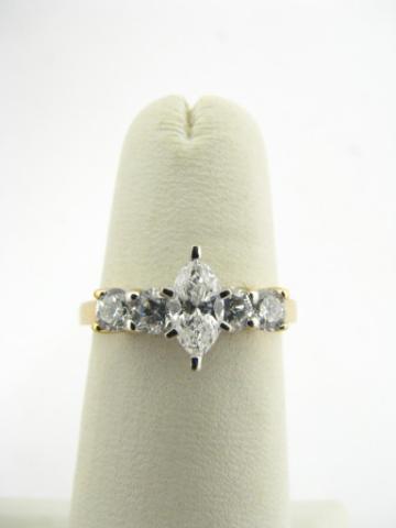 Appraisal: K Yellow gold ring with marquis cut diamond and four