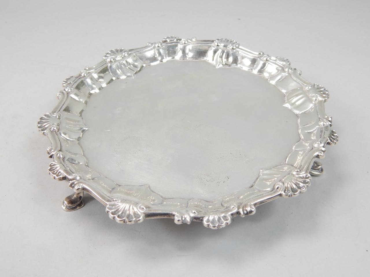 Appraisal: A small George II silver waiter with a pie crust