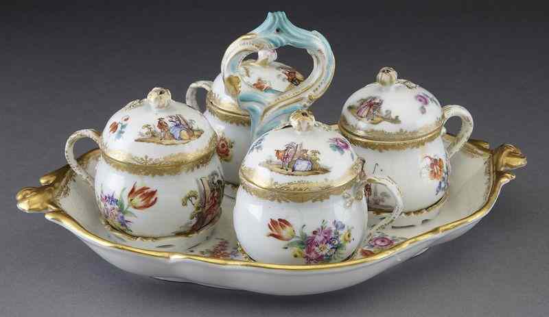 Appraisal: Meissen style porcelain condiment set four lidded cups painted with