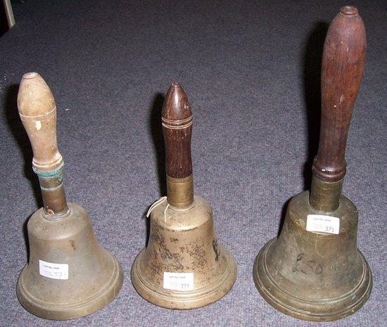 Appraisal: Three hand bells both with turned wood handles