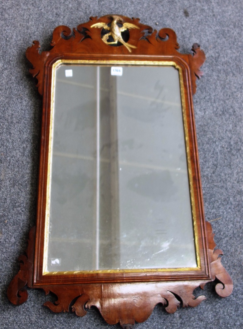 Appraisal: A George III parcel gilt fret cut wall mirror with