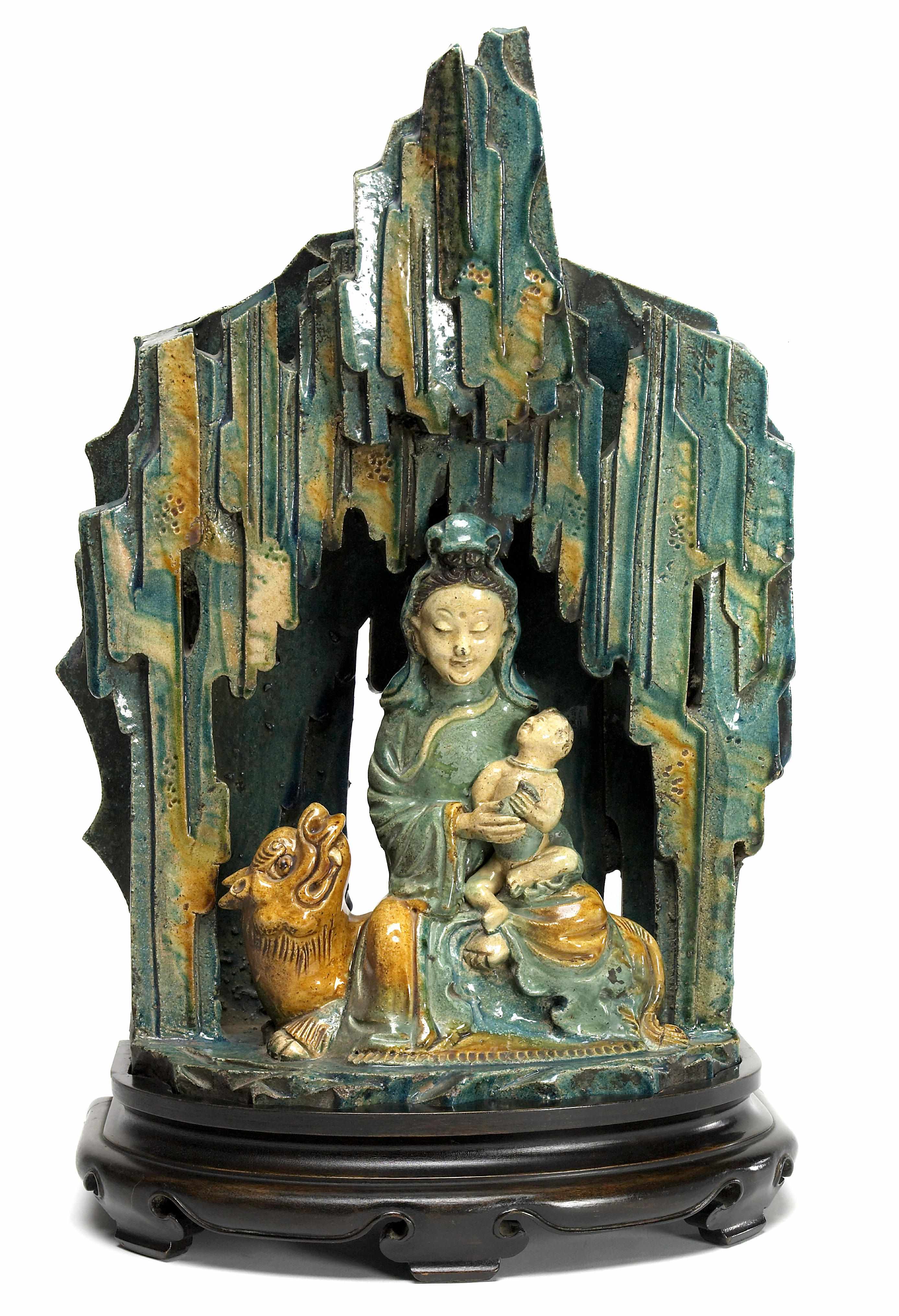 Appraisal: A Chinese glazed pottery model of Guanyin and a child