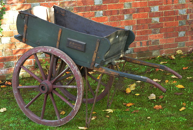 Appraisal: AN OLD GREEN PAINTED HAND BARROW with red painted spoked