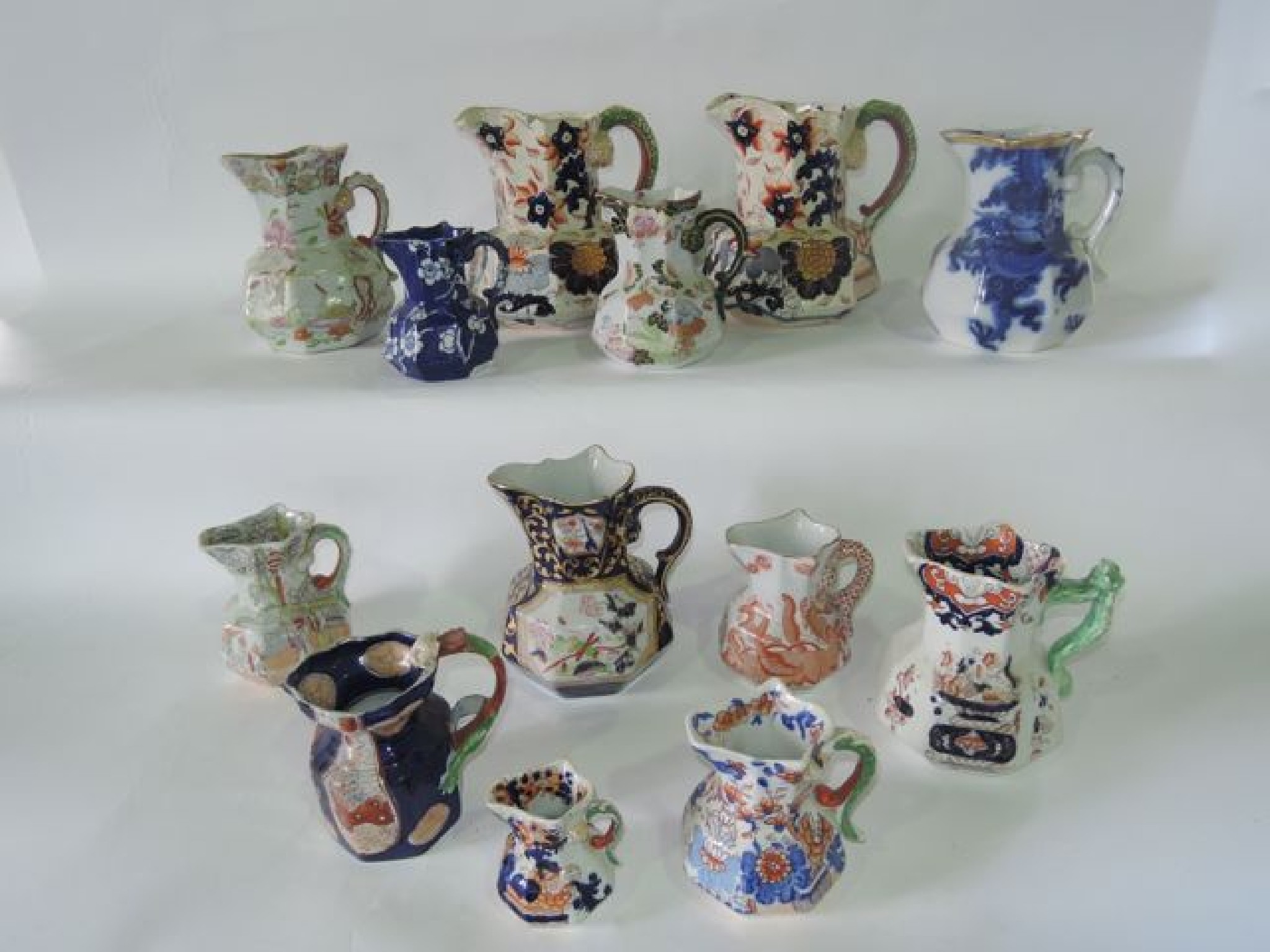 Appraisal: A collection of thirteen th century Ironstone jugs of various