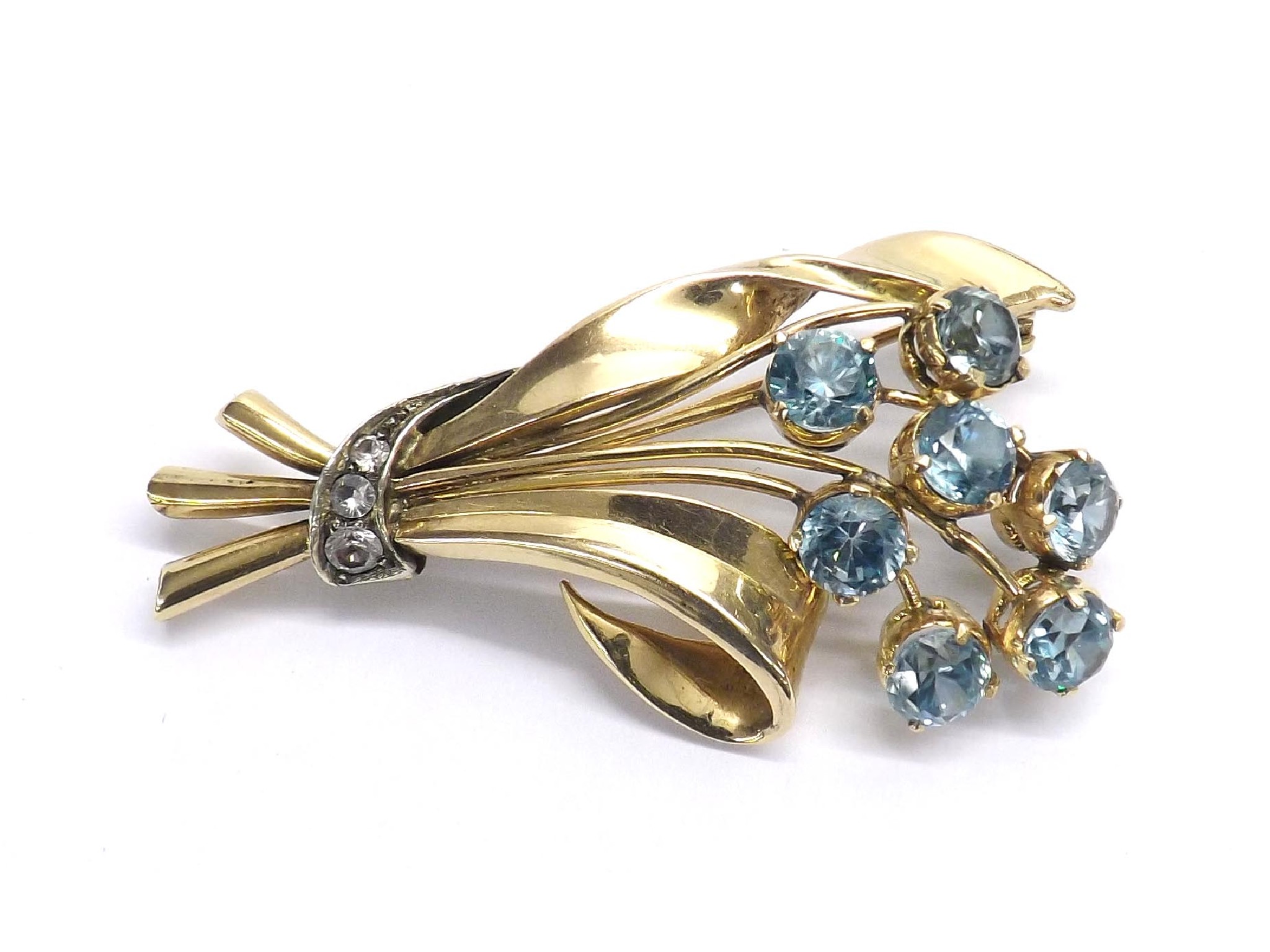 Appraisal: Yellow gold blue zircon and diamond floral brooch with seven