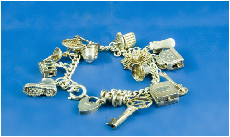 Appraisal: Silver Charm Bracelet Loaded With Charms Comprising Key Spiders Web