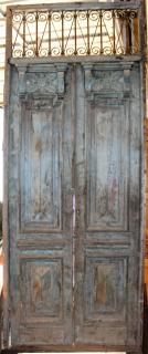 Appraisal: Pair of carved wood iron entry doors with transom Pair