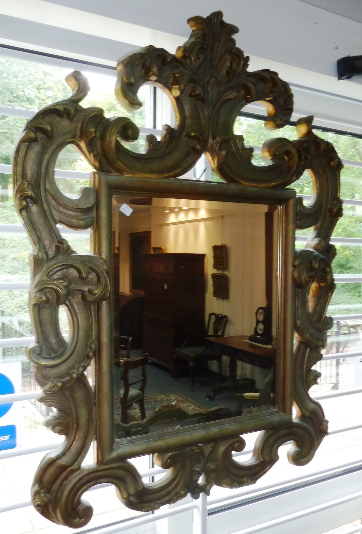 Appraisal: A carved wood and gilded wall mirror the frame carved