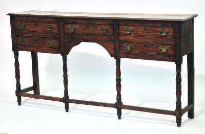 Appraisal: AN OAK LOW DRESSER with moulded edged top central frieze