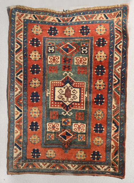 Appraisal: AN ANTIQUE CAUCASIAN KAZAK FACHRALO RUST GROUND RUG decorated a