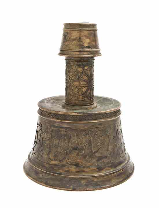 Appraisal: A Middle Eastern Bronze Candlestick with Arabic script and organic