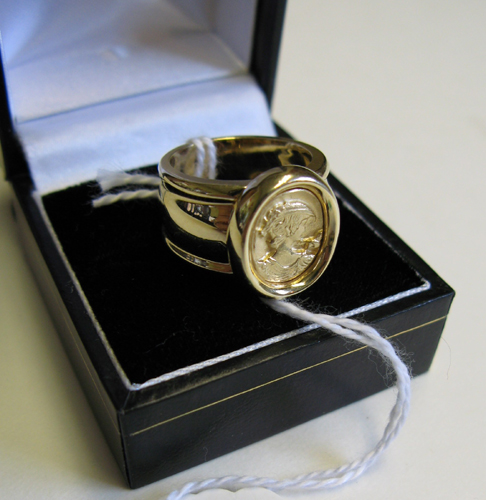 Appraisal: FOURTEEN KARAT GOLD RING with bezel-set gold portrait medallion of