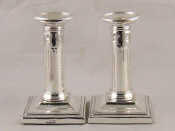 Appraisal: A pair of silver candlesticks with beaded square base and