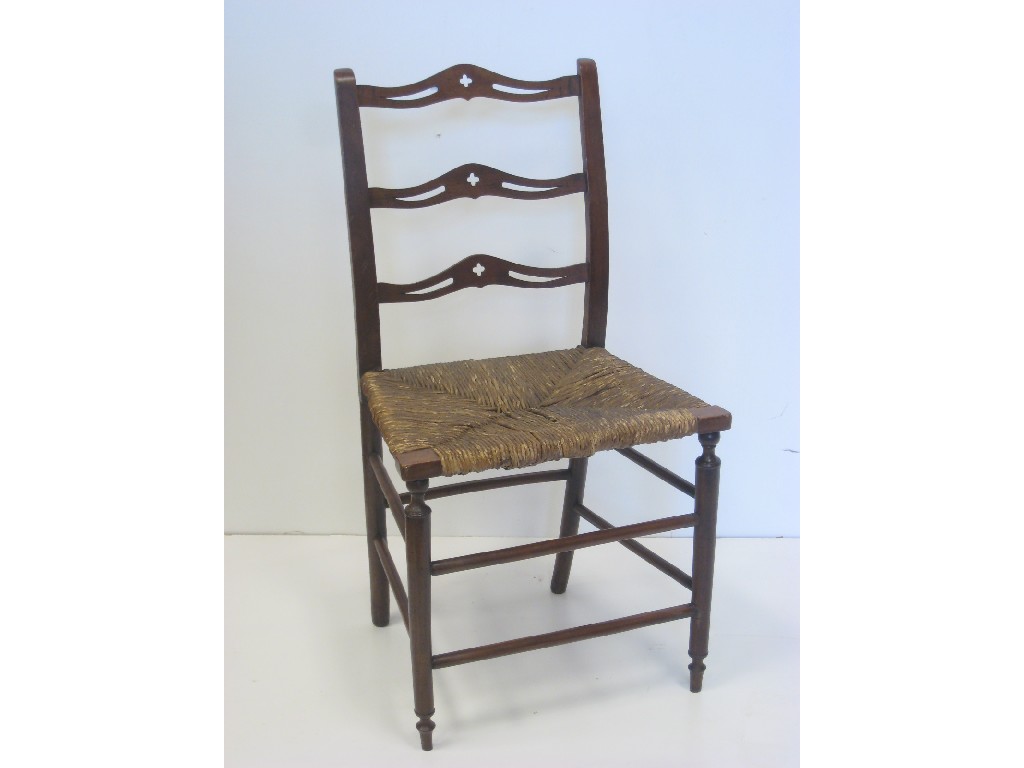 Appraisal: An antique rush seated Elbow Chair with ladder back on