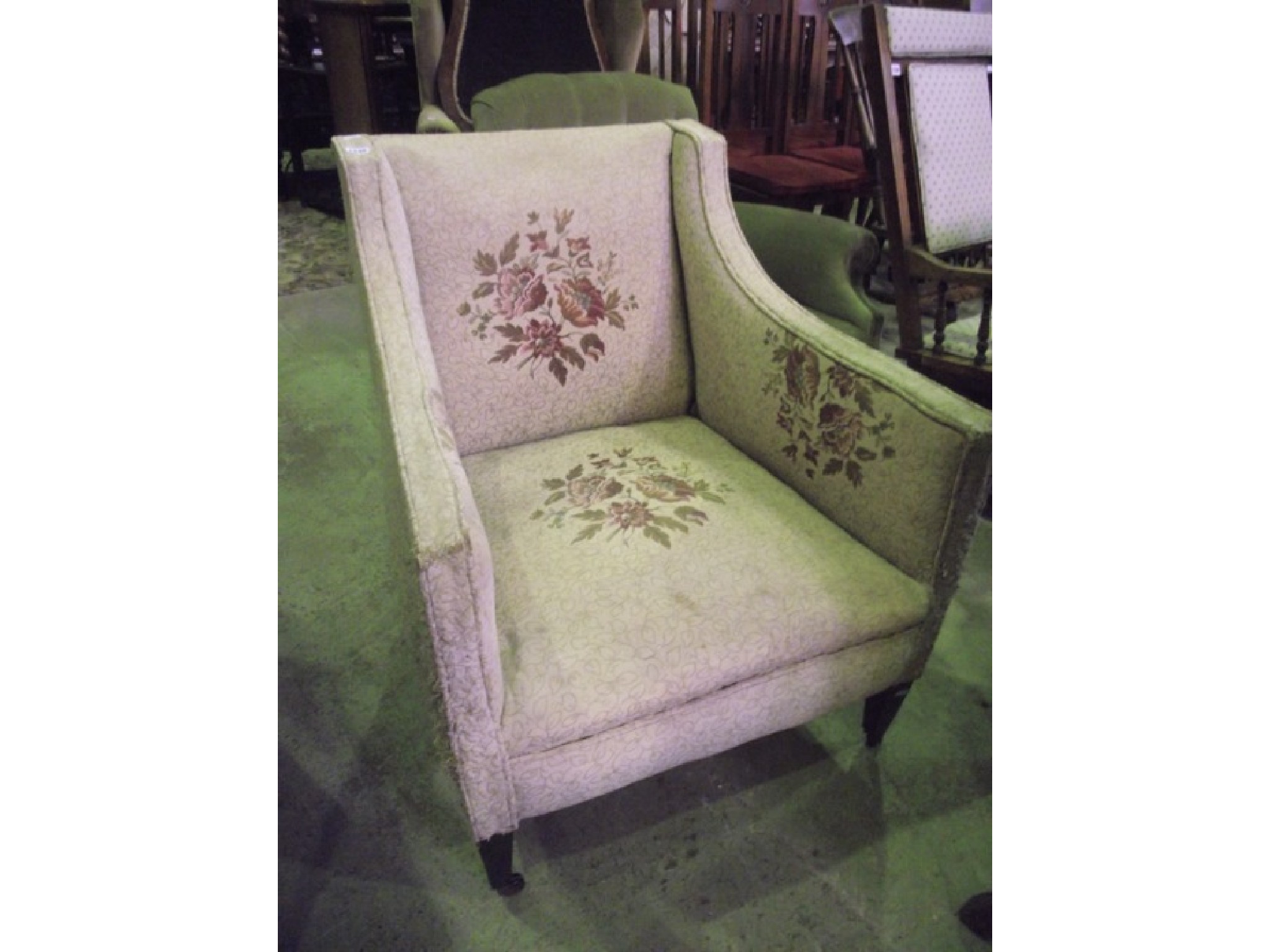 Appraisal: An Edwardian drawing room chair with down swept arms upholstered