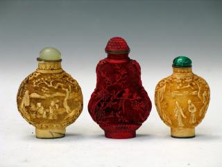 Appraisal: Three Chinese Cinnabar Snuff Bottles Three Chinese Cinnabar Snuff Bottles