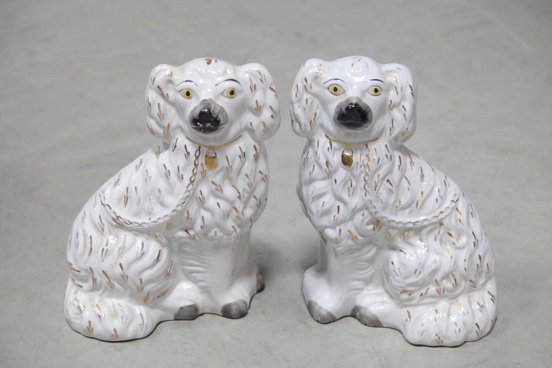 Appraisal: PAIR OF STAFFORDSHIRE DOGS English late th century Seated dogs