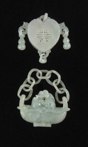 Appraisal: TWO CHINESE LIGHT GREEN JADE PENDANTS together weighing grams and